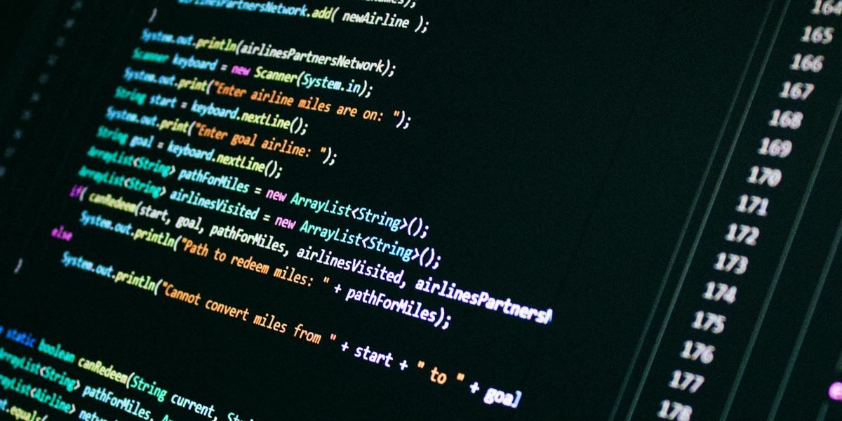 A diverse team collaborating, with one person pointing to a screen displaying video content, symbolizing the synergy between AI tools and human oversight.