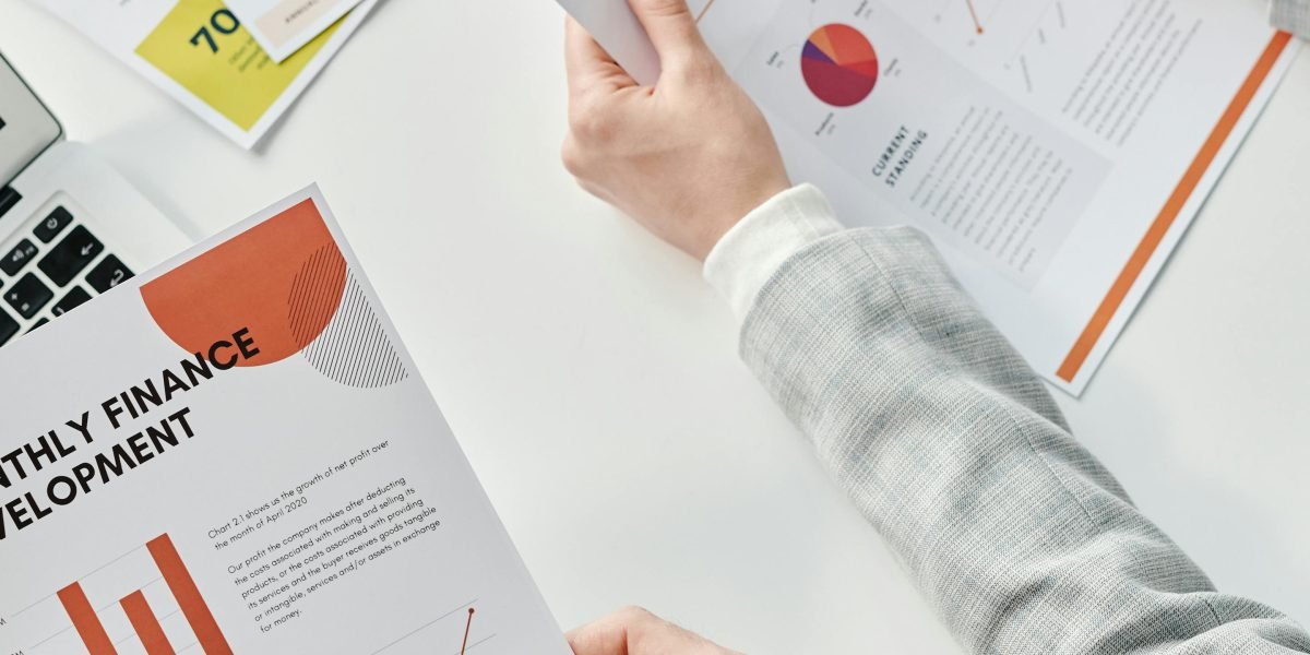 Business leaders in a serious discussion, reviewing reports that highlight the potential financial and reputational costs of AI errors.