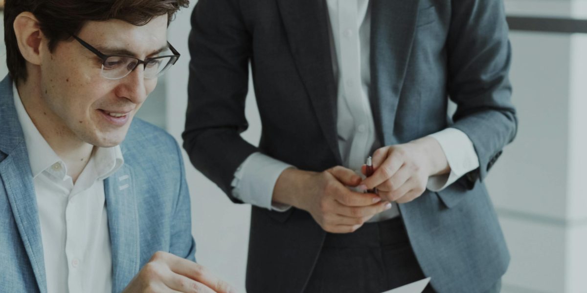 Legal or compliance professionals carefully examining documents related to AI governance and regulatory standards.