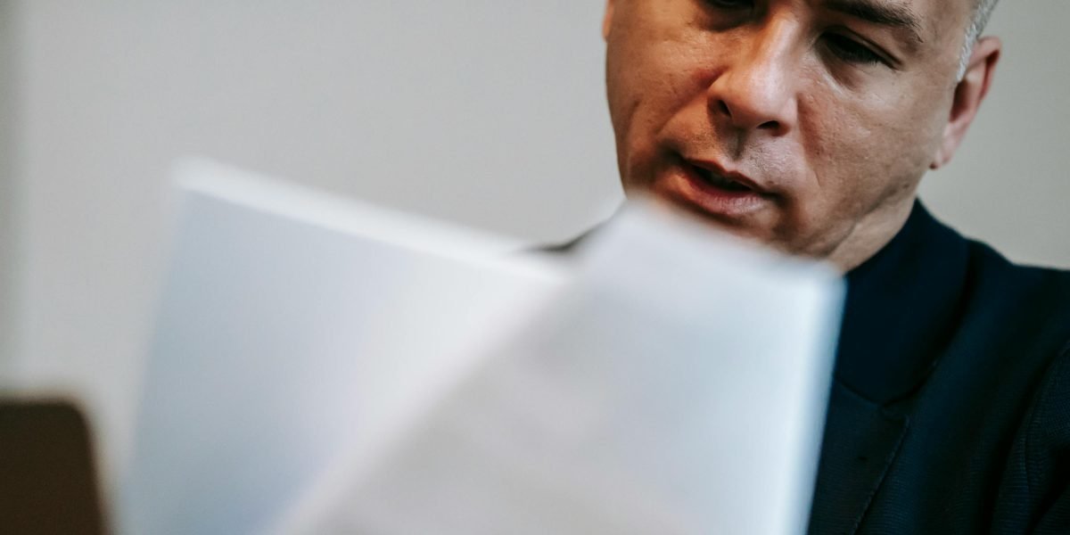A professional meticulously reviews documents, highlighting the need for vigilance when working with AI-generated content.
