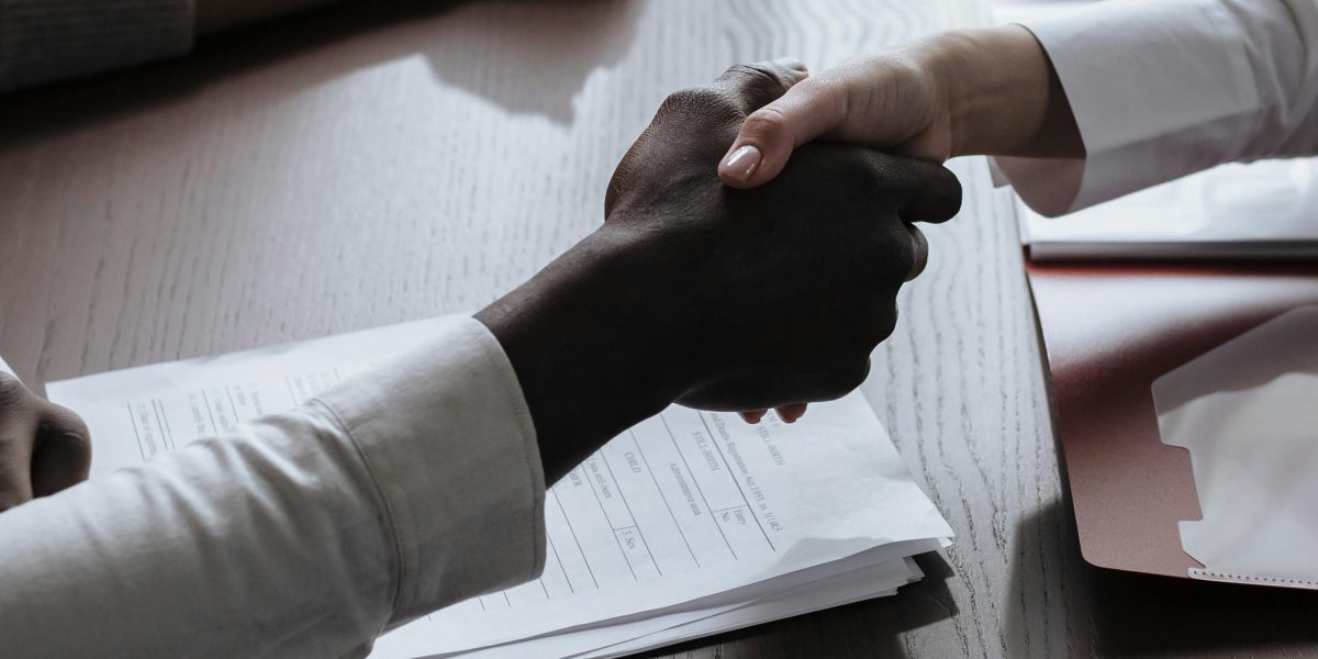 Two business professionals shaking hands, symbolizing successful collaboration and trust.