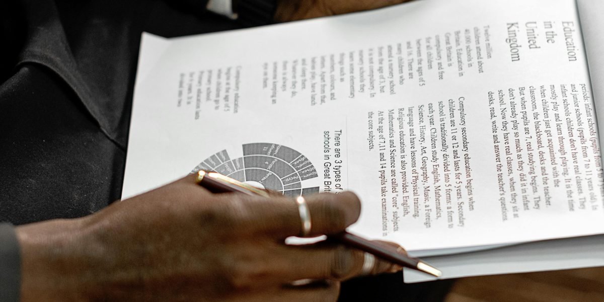 A professional meticulously reviewing legal documents, highlighting the need for careful human oversight.