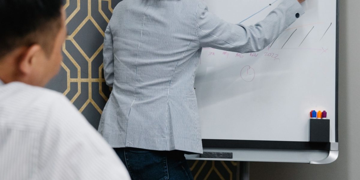 A team actively collaborating around a whiteboard or diagram, symbolizing the development of robust AI fact-checker workflows.