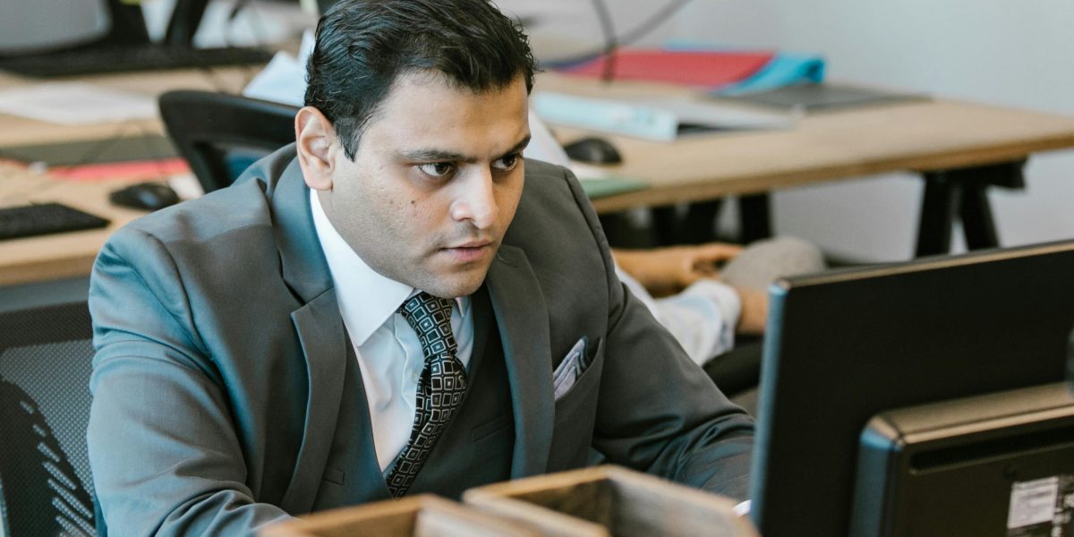A person intently focused on specific documents or tasks, symbolizing the specialized and narrow scope of domain-specific AI models.