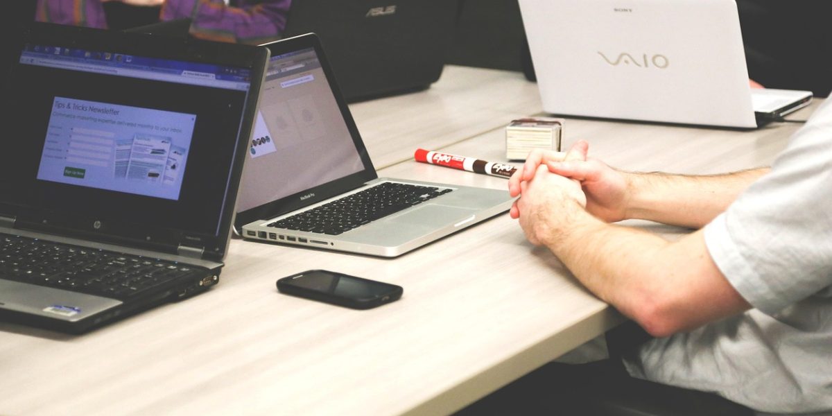 A team engages in a serious discussion, reflecting the high stakes of unchecked AI outputs in business.