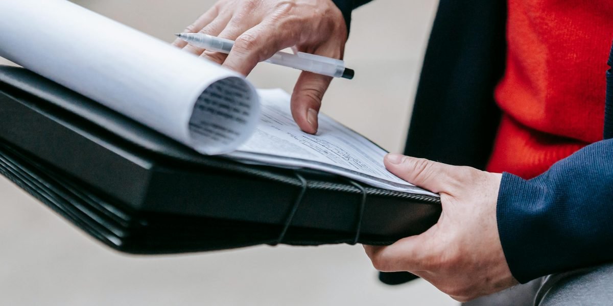 A person intently reviewing documents or data, perhaps with a slight look of concern or critical analysis.