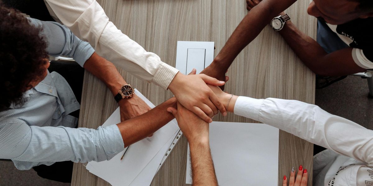 A group of professionals in a meeting, actively collaborating and writing notes on a whiteboard about new policies or guidelines.