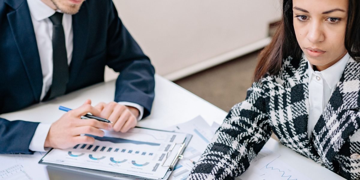 Business professionals analyze performance reports, assessing the impact and ROI of new collaboration technologies.