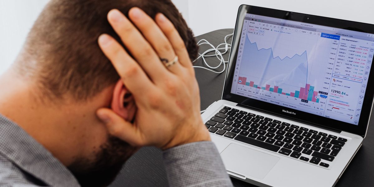 A security analyst appears overwhelmed by a deluge of alerts, symbolizing the challenge of AI-driven false positives.