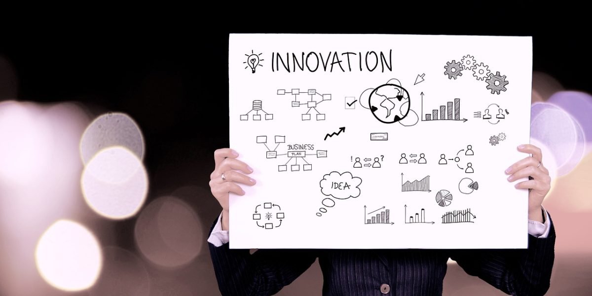 A professional drawing out a roadmap or framework on a whiteboard.