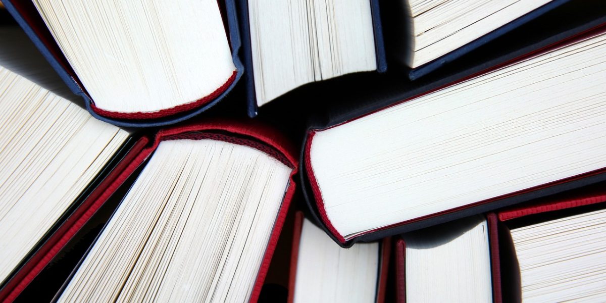 A person engaged in continuous learning, reading research papers to stay updated in the fast-evolving AI field.