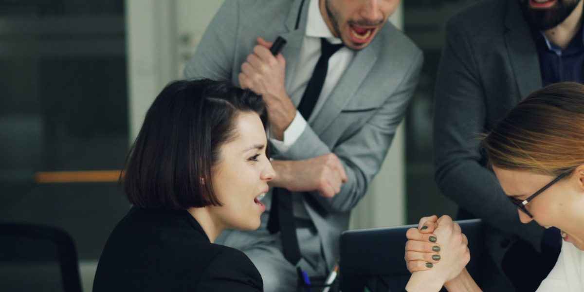 An HR team collaborates in an office, discussing strategies related to workforce trends and employee well-being.