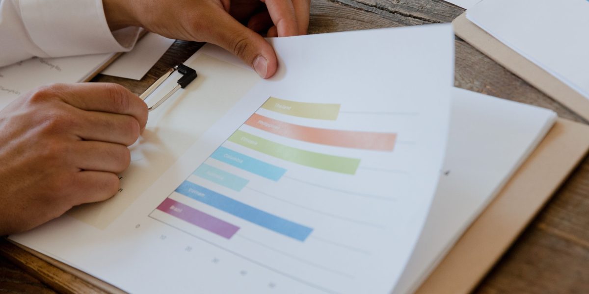 A person carefully reviews documents, representing the critical human element in data validation workflows.
