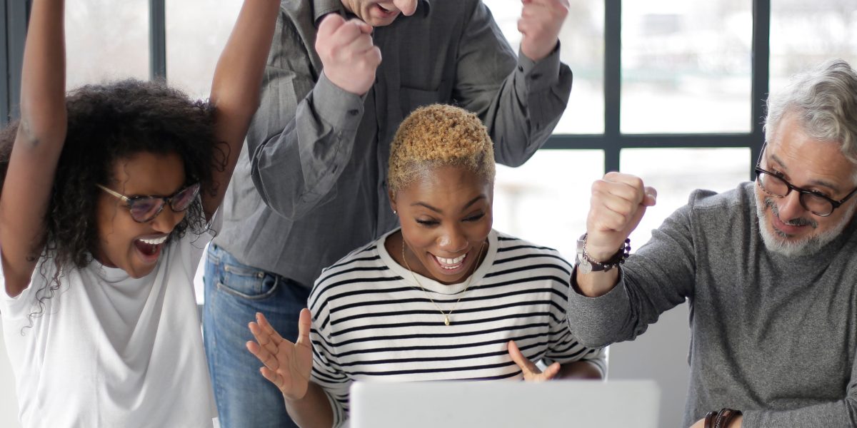Professionals celebrate a successful outcome, symbolizing the rewarding career opportunities in data quality.