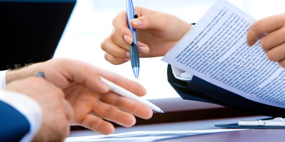 A person diligently reviews documentation, emphasizing the importance of auditability and compliance for AI systems.